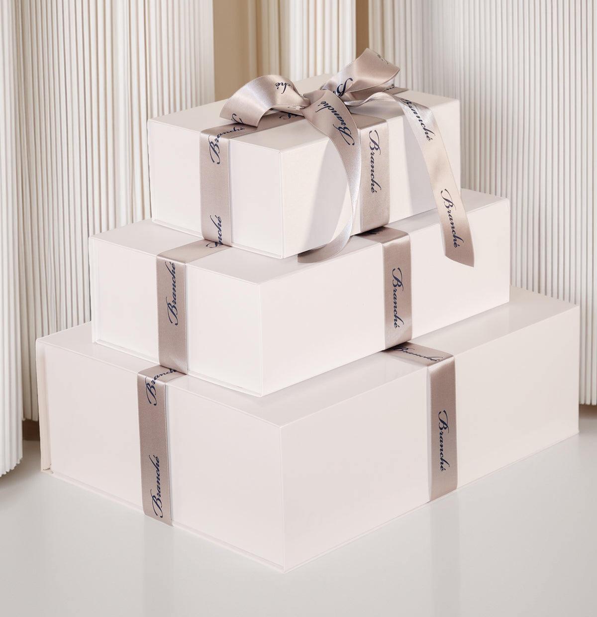 Signature Branché white gift boxes finished with satin ribbon